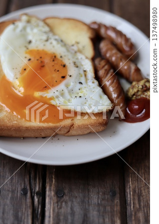 Toast topped with crumbled soft-boiled eggs and coarsely ground sausages Toast topped with crumbled soft-boiled eggs and coarsely ground sausages 137498980