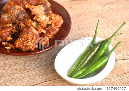 fried fermenting sour pork bone with garlic eat copple fresh chili on plate fried fermenting sour pork bone with garlic eat copple fresh chili on plate 137499027