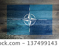 NATO flag on rustic old wood surface background 137499143