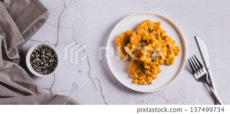 Golden crispy corn fritters on a plate on the table top view web banner Golden crispy corn fritters on a plate on the table top view web banner 137499734