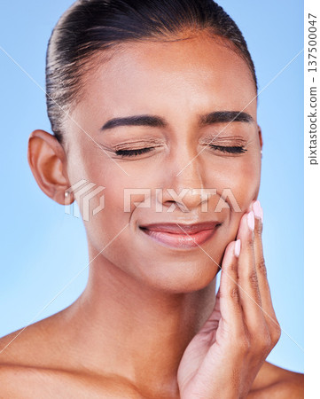 Toothache, sad and a woman with mouth pain on a blue background with a dental emergency. Dentist, frustrated and a girl with a problem with a teeth injury, gingivitis or inflammation of a gum 137500047