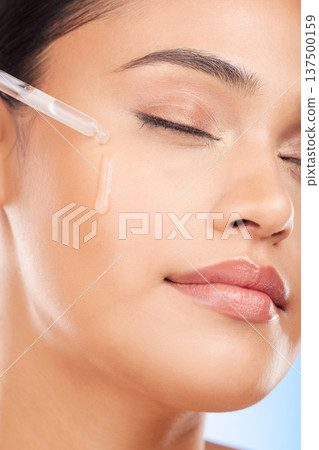 Face, oil and woman in studio for skincare, wellness or hydration, serum or cosmetic application. Beauty, facial and female model with hydration, vitamin c or retinol, hyaluronic acid or skin primer 137500159
