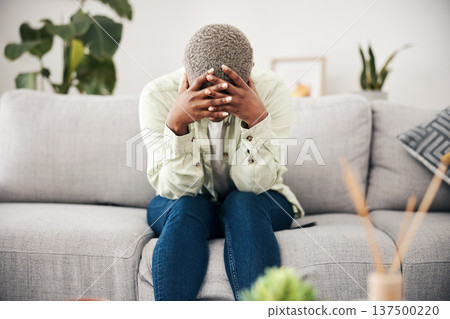 Woman, headache and depression on sofa for mental health, anxiety and stress of bad mistake at home. Crying, sad and frustrated african person scared of trauma, worry and counselling of broken heart Woman, headache and depression on sofa for mental health, anxiety and stress of bad mistake at home. Crying, sad and frustrated african person scared of trauma, worry and counselling of broken heart 137500220