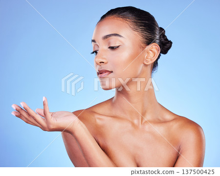 Hand, thinking and woman on a blue background for beauty, advertising or skincare in studio. Fingers, idea and Indian model with a gesture or palm for makeup, glow of skin or marketing on a backdrop Hand, thinking and woman on a blue background for beauty, advertising or skincare in studio. Fingers, idea and Indian model with a gesture or palm for makeup, glow of skin or marketing on a backdrop 137500425