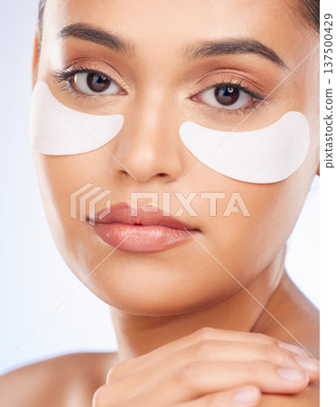 Skincare, beauty and portrait of woman with collagen eye patch for anti aging or skin pad on white background. Cosmetics, facial detox and model with luxury mask or product for dermatology in studio. Skincare, beauty and portrait of woman with collagen eye patch for anti aging or skin pad on white background. Cosmetics, facial detox and model with luxury mask or product for dermatology in studio. 137500429