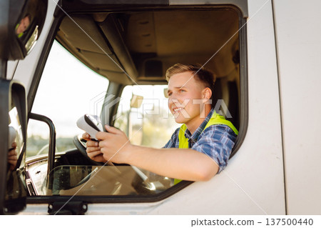 Truck driver job. Logistics - proud driver or forwarder on truck and trailer, on transshipment point 137500440