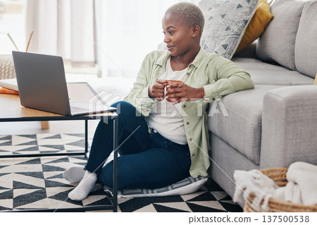 Woman, coffee and watch movies on laptop, streaming multimedia or news show on floor of home. Happy african person relax with cup of tea, computer or social media subscription of online entertainment 137500538