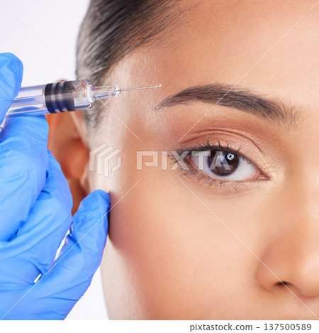 Eyebrow, woman and portrait of injection, plastic surgery and facial beauty process on white background in studio. Closeup, facelift and needle at eyes for aesthetic filler, skincare or prp cosmetics Eyebrow, woman and portrait of injection, plastic surgery and facial beauty process on white background in studio. Closeup, facelift and needle at eyes for aesthetic filler, skincare or prp cosmetics 137500589