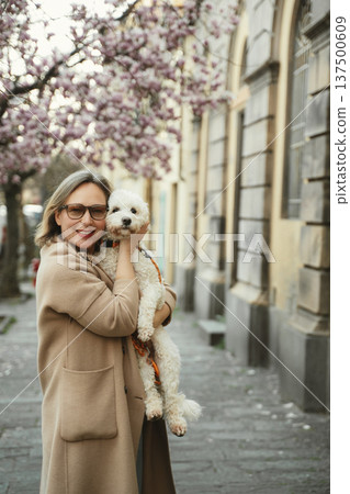 Woman Hugging Dog with Cherry Blossoms in Background Woman Hugging Dog with Cherry Blossoms in Background 137500609