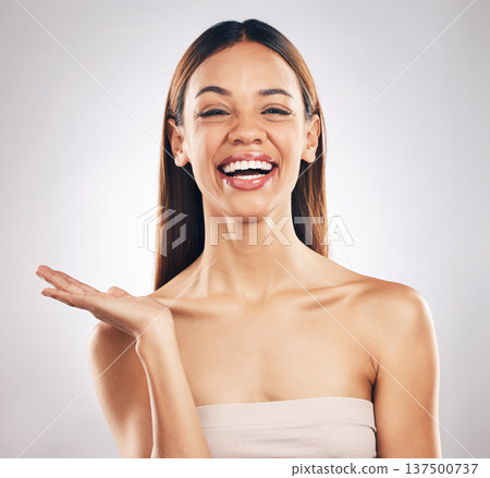 Portrait, woman and hand for beauty, skincare or advertising offer, space or mockup for marketing on white background in studio. Makeup, deal and smile on face for choice, cosmetics or palm for logo 137500737