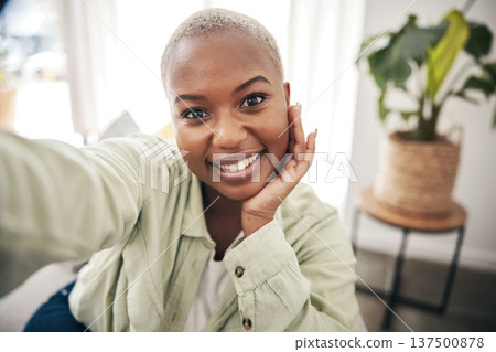 Home, portrait or black woman taking a selfie with a happy smile on sofa to post on social media. Apartment, face or African person taking a photo, vlog or picture on couch in living room to relax 137500878