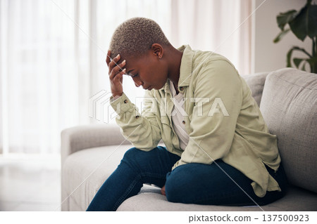 Woman, headache and depression on sofa for sad memory, mental health and frustrated anxiety at home. Stress, worry and lonely african person in trauma of ptsd, broken heart and bad crisis for mistake 137500923
