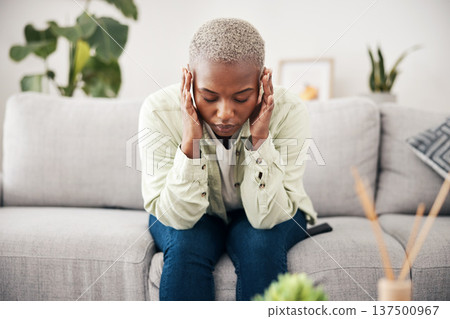 Anxiety, headache and pain with a black woman on a sofa in the living room of her home for mental health. Stress, burnout or vertigo and a young person in an apartment with depression or a migraine 137500967
