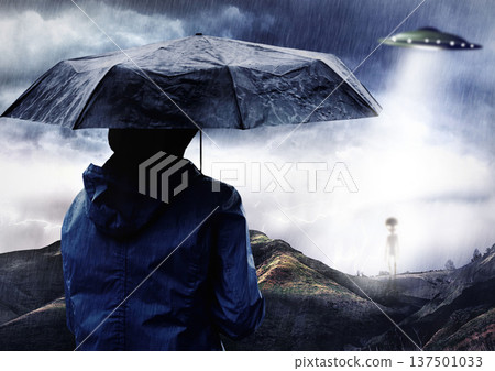 Rain umbrella, man and ufo of alien outdoor on spaceship in science fiction mystery on countryside adventure. Flying saucer, back and person with extraterrestrial object for night abduction in storm Rain umbrella, man and ufo of alien outdoor on spaceship in science fiction mystery on countryside adventure. Flying saucer, back and person with extraterrestrial object for night abduction in storm 137501033