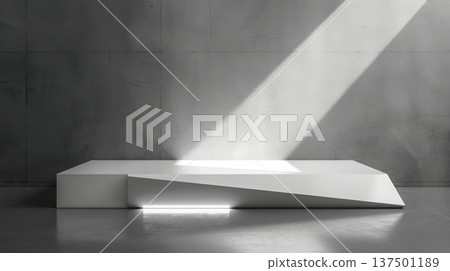 A striking piece of white minimalist sculpture art, illuminated by a focused sunbeam, is displayed in a modern gallery with gray walls at midday. 137501189