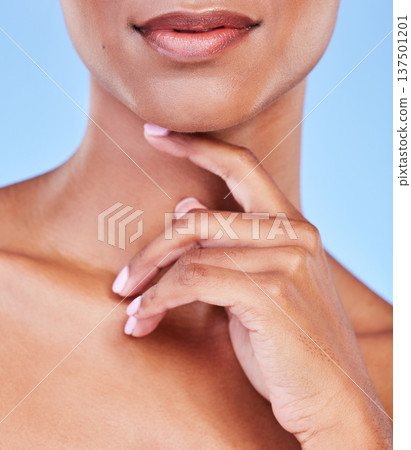 Hand, mouth and beauty with a woman closeup in studio on a blue background for natural skin wellness. Skincare, lips and finger of a model touching her face for an aesthetic manicure or cosmetics Hand, mouth and beauty with a woman closeup in studio on a blue background for natural skin wellness. Skincare, lips and finger of a model touching her face for an aesthetic manicure or cosmetics 137501201