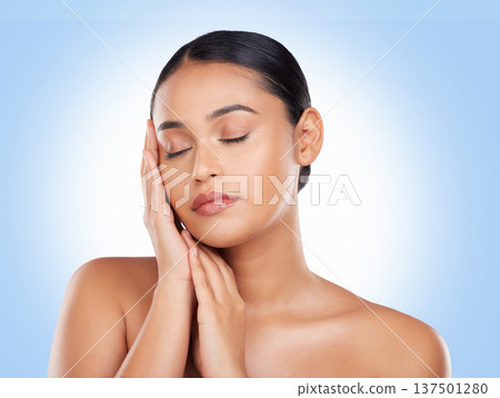 Skincare, beauty and woman with cosmetics, shine and dermatology on a blue studio background. Glow, person or model with luxury, self care or facial with aesthetic, soft or healthy skin with wellness Skincare, beauty and woman with cosmetics, shine and dermatology on a blue studio background. Glow, person or model with luxury, self care or facial with aesthetic, soft or healthy skin with wellness 137501280