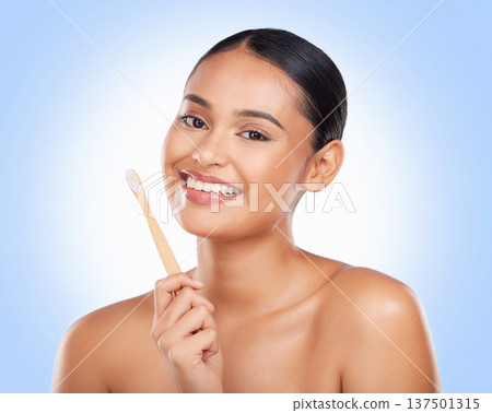 Happy portrait, woman and brushing teeth in studio for dental care, gingivitis and sustainable cosmetics on blue background. Model with bamboo toothbrush cleaning mouth, oral hygiene or healthy smile Happy portrait, woman and brushing teeth in studio for dental care, gingivitis and sustainable cosmetics on blue background. Model with bamboo toothbrush cleaning mouth, oral hygiene or healthy smile 137501315