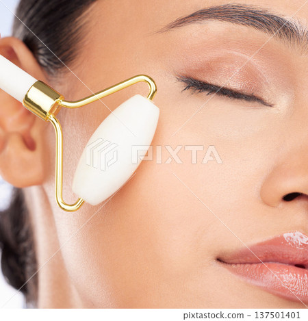 Woman, face roller and closeup for beauty, healthy skincare benefits and aesthetic dermatology. Model, crystal cosmetics product and facial massage tools for lymphatic drainage, collagen and shine Woman, face roller and closeup for beauty, healthy skincare benefits and aesthetic dermatology. Model, crystal cosmetics product and facial massage tools for lymphatic drainage, collagen and shine 137501401