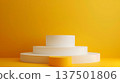 White cylindrical pedestals are arranged in a tiered fashion against a vibrant yellow backdrop, creating a minimalist and modern design. 137501806