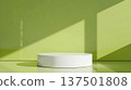A round, white pedestal is set against a lime green backdrop. Sunlight casts diagonal shadows on the walls, creating a minimalist and modern aesthetic. 137501808
