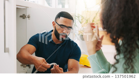 Plumber black man, woman and maintenance talk in kitchen for sink pipe with customer support in home. Entrepreneur handyman, plumbing or small business owner with consulting for fixing water system Plumber black man, woman and maintenance talk in kitchen for sink pipe with customer support in home. Entrepreneur handyman, plumbing or small business owner with consulting for fixing water system 137501962