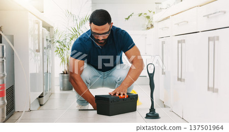 Plumber man, tools and box on floor maintenance with packing, focus and pipe repair service in house. Entrepreneur handyman, plumbing expert and small business owner with toolbox in home kitchen 137501964