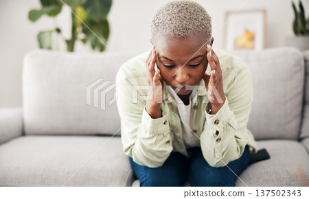 Burnout, headache and pain with a black woman on a sofa in the living room of her home for mental health. Anxiety, stress or vertigo and a young person in an apartment with depression or a migraine Burnout, headache and pain with a black woman on a sofa in the living room of her home for mental health. Anxiety, stress or vertigo and a young person in an apartment with depression or a migraine 137502343