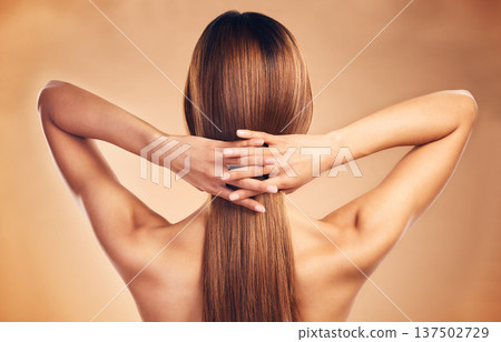 Studio, back and person with long hair care, healthy texture shine and strong extensions, cosmetic treatment or keratin results. Hairdressing spa, beauty salon and model hairstyle on brown background Studio, back and person with long hair care, healthy texture shine and strong extensions, cosmetic treatment or keratin results. Hairdressing spa, beauty salon and model hairstyle on brown background 137502729