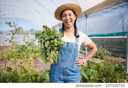 Farming, agriculture and woman with vegetables in a greenhouse for health and sustainability. Portrait of a young farmer with spinach for eco lifestyle, agro startup or organic food for wellness Farming, agriculture and woman with vegetables in a greenhouse for health and sustainability. Portrait of a young farmer with spinach for eco lifestyle, agro startup or organic food for wellness 137502752
