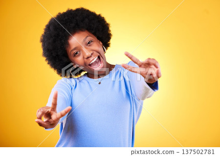 Peace, hand sign and portrait of a woman in studio with fun emoji, excited face and v symbol. Happy african person on yellow background for positive mood, motivation and review with gesture or vote Peace, hand sign and portrait of a woman in studio with fun emoji, excited face and v symbol. Happy african person on yellow background for positive mood, motivation and review with gesture or vote 137502781