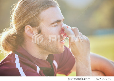 Nose bleed, man closeup and sports injury closeup on field with emergency, health accident and blood outdoor. Swollen, broken and male athlete with medical and pain or bruise after game and exercise Nose bleed, man closeup and sports injury closeup on field with emergency, health accident and blood outdoor. Swollen, broken and male athlete with medical and pain or bruise after game and exercise 137502789