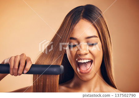Excited, hair straightener and beauty of a woman in studio for cosmetics or mockup. Aesthetic model on brown background for wow heat treatment, healthy results and hairdresser or salon flat iron Excited, hair straightener and beauty of a woman in studio for cosmetics or mockup. Aesthetic model on brown background for wow heat treatment, healthy results and hairdresser or salon flat iron 137502790