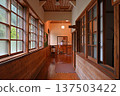 A nostalgic corridor in a wooden school building with beautiful polished wooden floors and ceilings 137503422