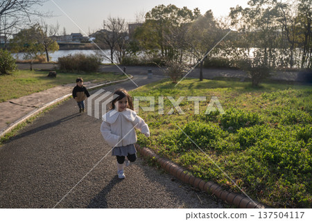Girls playing in the park Girls playing in the park 137504117