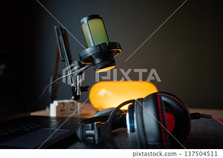 Microphone, headphones and laptop on desk in home recording studio 137504511