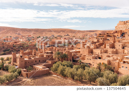 Moroccan kasbah Ait Ben Haddou with tourists exploring its ancient architecture Moroccan kasbah Ait Ben Haddou with tourists exploring its ancient architecture 137504645