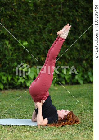 Healthy Lifestyle Woman Practicing Yoga in Nature Healthy Lifestyle Woman Practicing Yoga in Nature 137505404