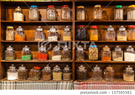 Traditional bedouin herbal pharmacy shelves with jars of medicinal herbs tea and natural remedies Traditional bedouin herbal pharmacy shelves with jars of medicinal herbs tea and natural remedies 137505561