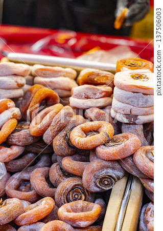 Traditional craft: handmade persimmon mochi with natural wind drying under sunlight and natural sugar frosting Traditional craft: handmade persimmon mochi with natural wind drying under sunlight and natural sugar frosting 137506003