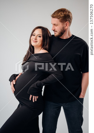 Couple celebrating pregnancy with joyful embrace at studio 137506270