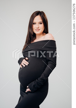 Expecting mother poses in elegant maternity dress Expecting mother poses in elegant maternity dress 137506276