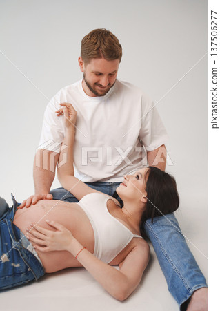 Couple sharing a joyful moment during pregnancy session Couple sharing a joyful moment during pregnancy session 137506277