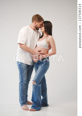 Couple shares a tender moment during pregnancy celebration 137506314