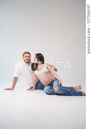 Couple celebrating pregnancy with joyful love at studio 137506347