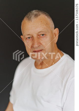 Senior man in white shirt with neutral background 137506376