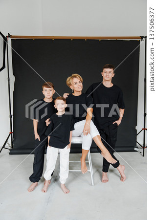 Family together during a studio photo session wearing black shirts Family together during a studio photo session wearing black shirts 137506377