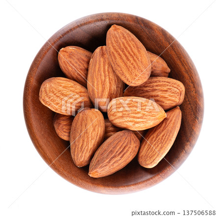 Almond nut isolated on white background. Brown almond nuts in wooden bowl. Clipping path. Top view. Almond nut isolated on white background. Brown almond nuts in wooden bowl. Clipping path. Top view. 137506588