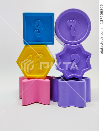 Colorful plastic geometric shape with numbers on white background. Number 3, 7, 12, and 2 137506806