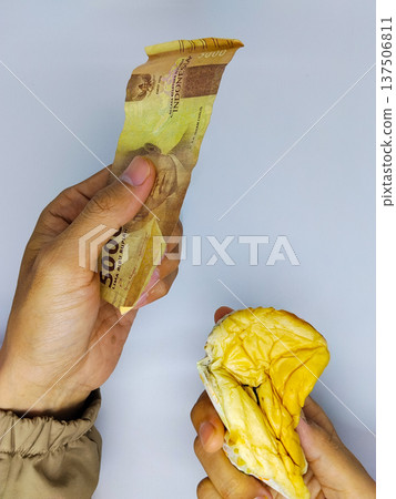 asian man buy bread with one Indonesian rupiah banknote asian man buy bread with one Indonesian rupiah banknote 137506811